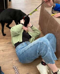 Student playing with Guide Dog