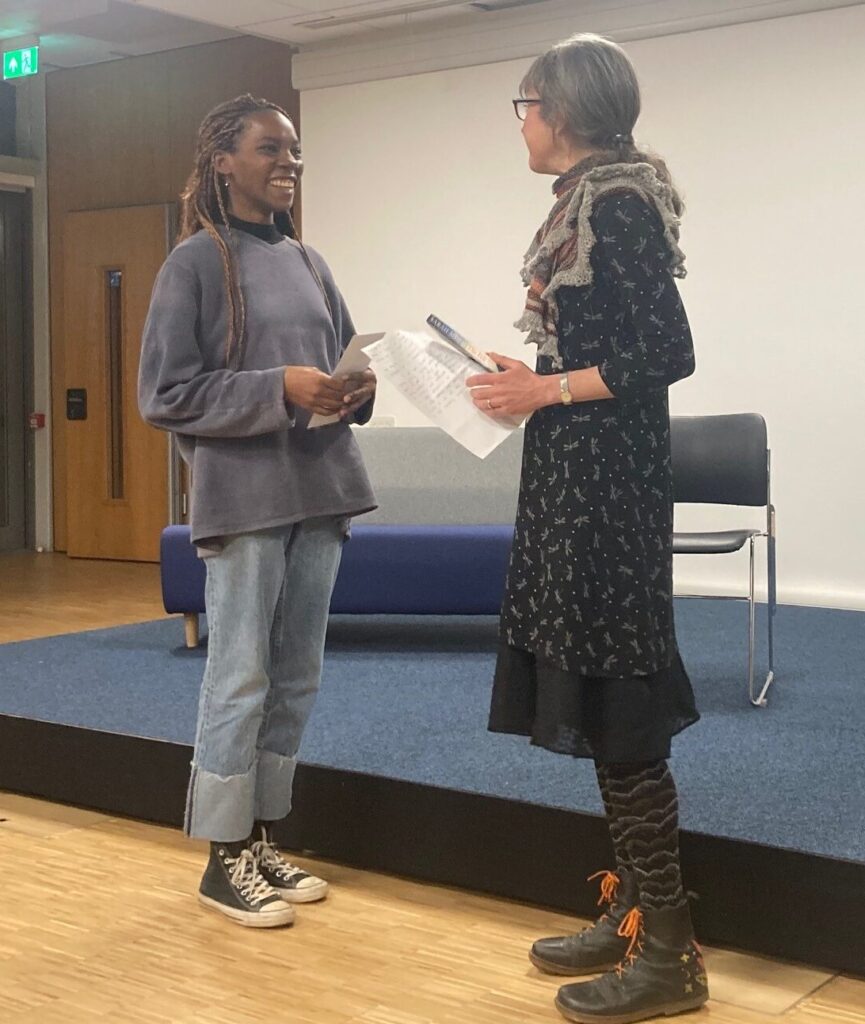 Kanengo receiving her award from Sarah Moss