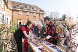 Group of alumnae looking at photo memories of their time at St Hugh's