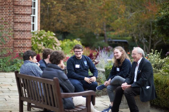 Prospective students speaking with current students and Prof Garnett