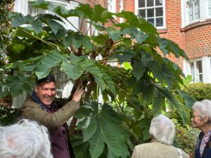 The Head Gardener under a tree during his tour of the gardens