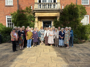 Group shot of alumni with the Principal on the terrace