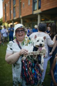 Attendee carrying her dog that won prize for 'best biscuit catcher'