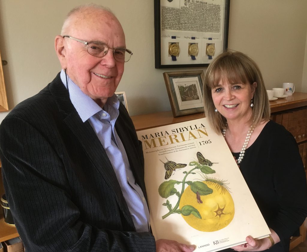 Alan Todd & the Principal, Dame Elish Angiolini, holding up a copy of the book donated to the College
